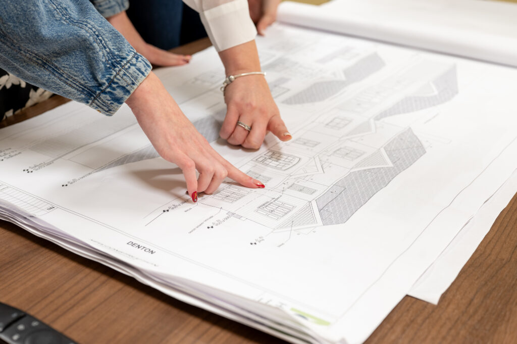 MC Homes designers going over blueprints for a build