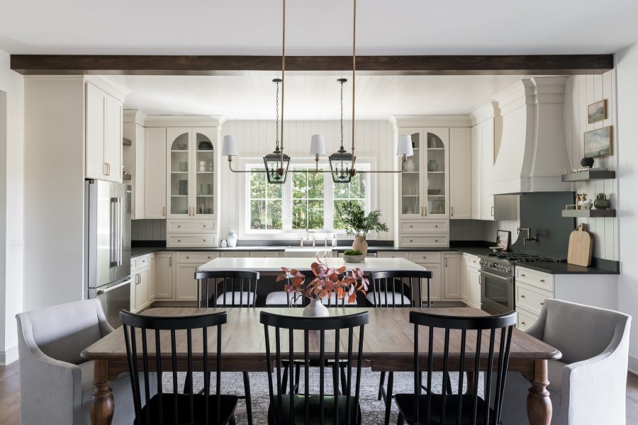 straight view of a dining room table in front of a kitchen island and the kitchen in the background